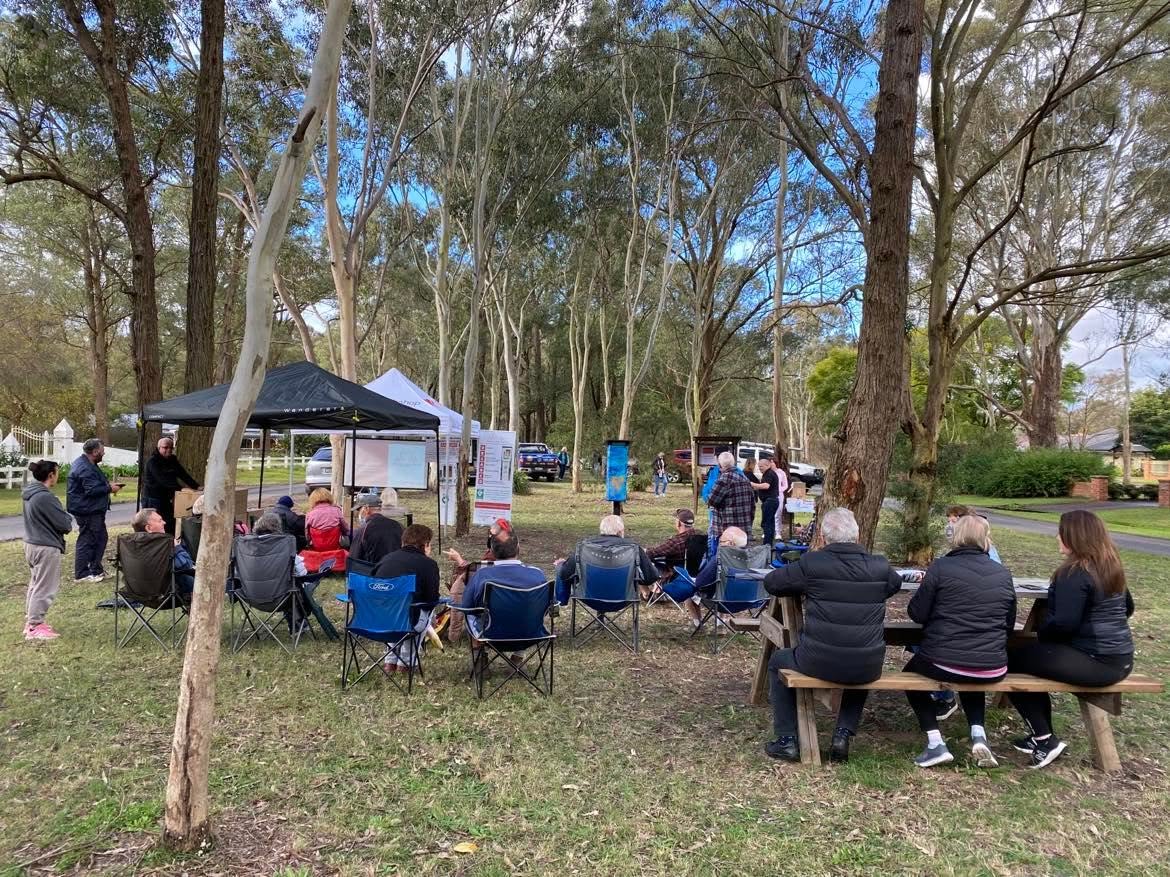 Community members attending an outdoor awareness session